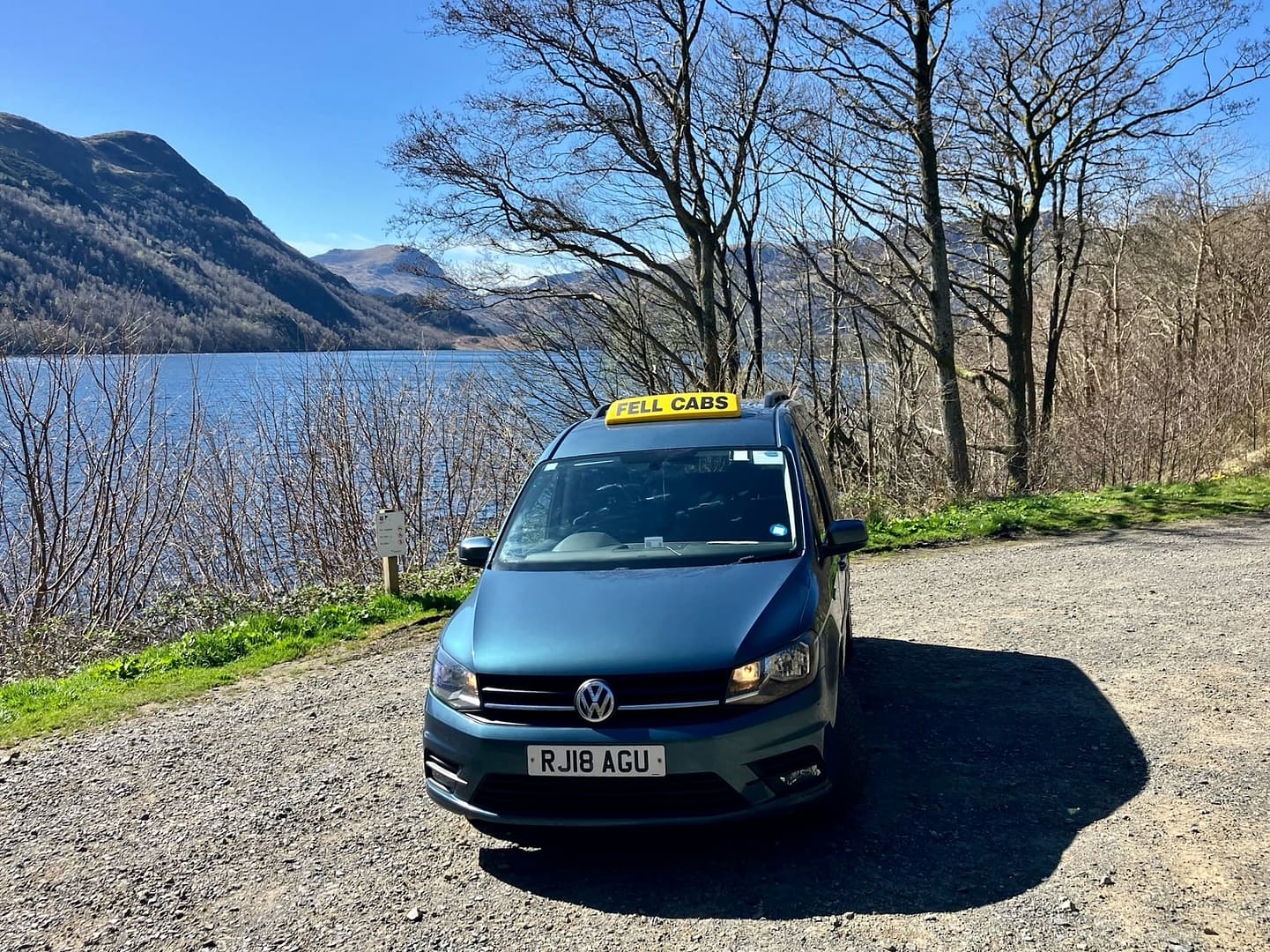 Fell Cabs parked on a sunny day next to Ullswater Lake in the Lake District
